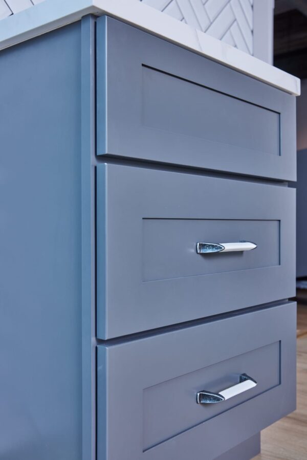 Blue kitchen cabinet with silver handle.