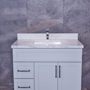 White bathroom vanity with marble countertop and modern faucet.