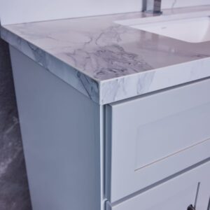 Modern bathroom vanity with marble countertop and chrome faucet.