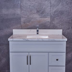 Gray bathroom vanity with marble countertop and modern faucet.