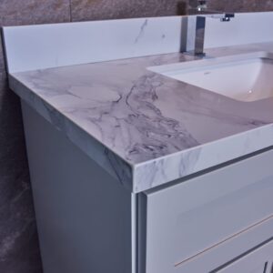 Marble countertop with integrated sink and modern faucet.