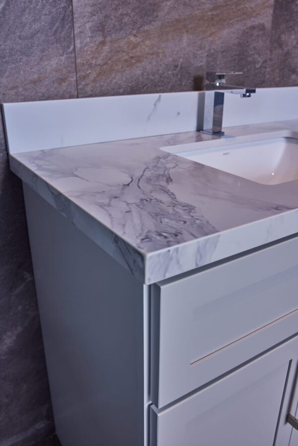 Marble countertop with integrated sink and modern faucet.
