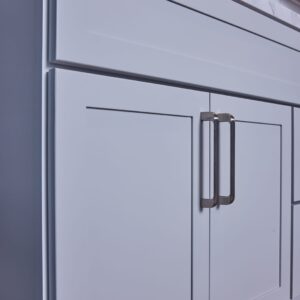 White kitchen cabinet with modern handles.
