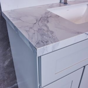 Modern bathroom vanity with marble countertop and sleek faucet.
