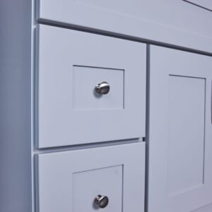 White kitchen cabinet with silver knobs.
