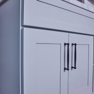 Modern kitchen cabinet with marble countertop and sleek handles.