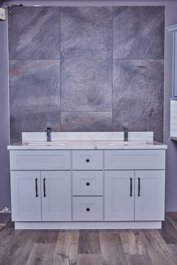 Modern bathroom vanity with dual sinks and gray stone backsplash.