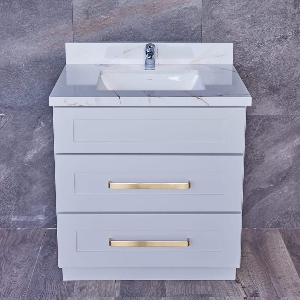 Modern bathroom vanity with marble countertop and gray tile wall.