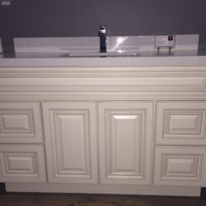 White kitchen cabinet with sink and faucet.