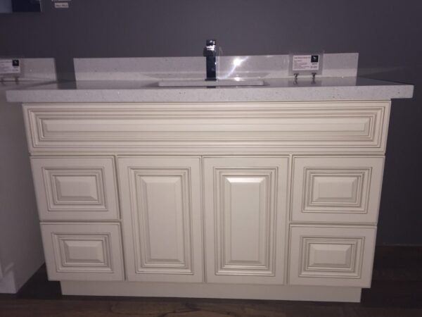 White kitchen cabinet with sink and faucet.