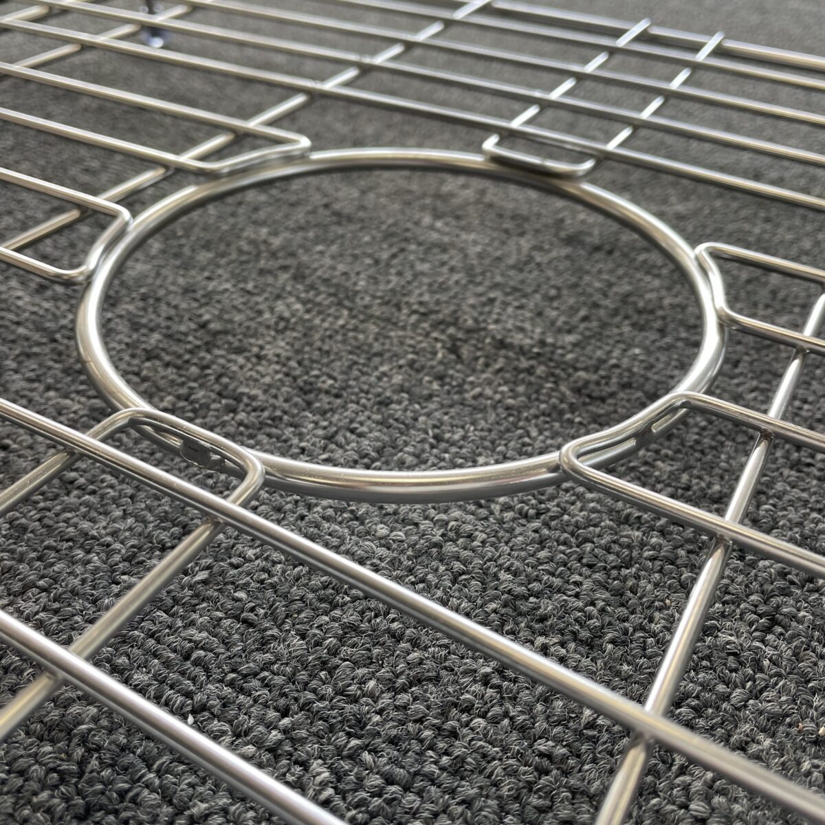 Butler sink protector on textured surface, close-up view.