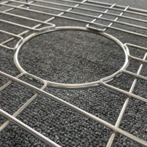 Butler sink protector on textured surface, close-up view.