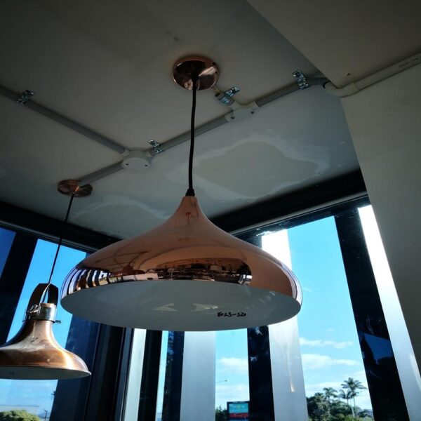 jl8023rg.jpg Copper pendant lights hanging from a ceiling in a modern kitchen.