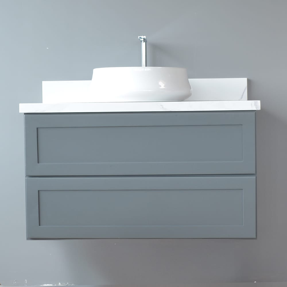 Gray wall-mounted vanity with white sink against a light gray wall.
