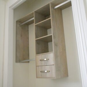 Wooden wardrobe with shelves and drawers inside a closet space.