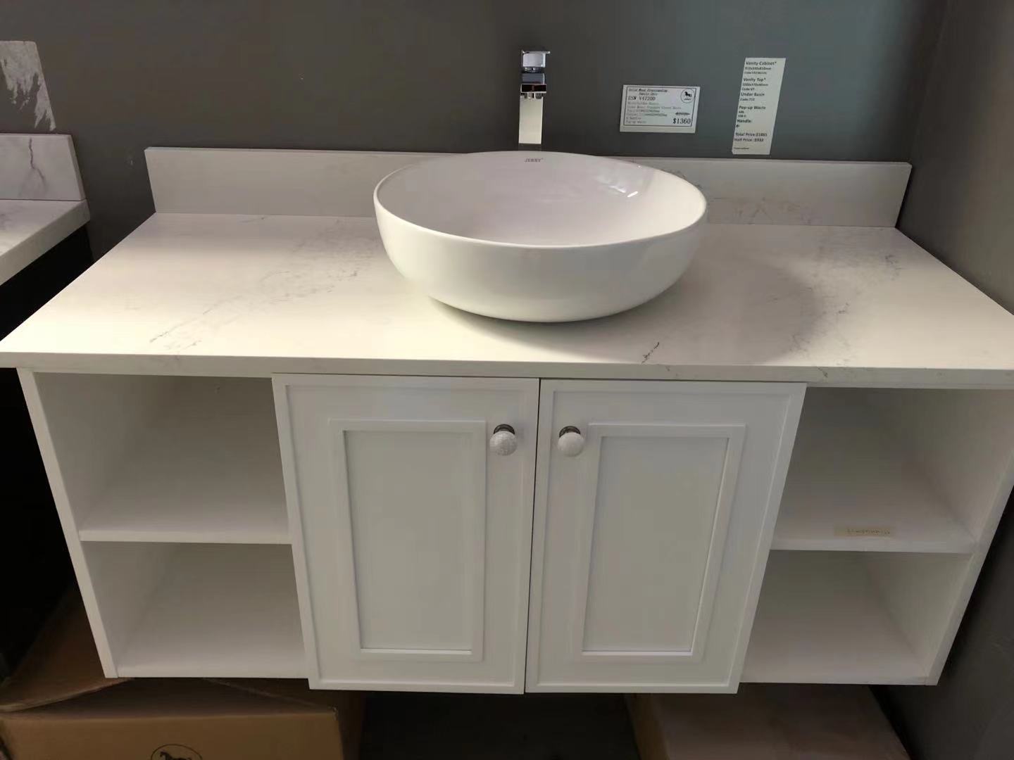 White bathroom vanity with round basin and storage shelves.