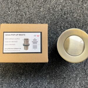 Bronze 32mm pop-up waste with packaging on carpet.