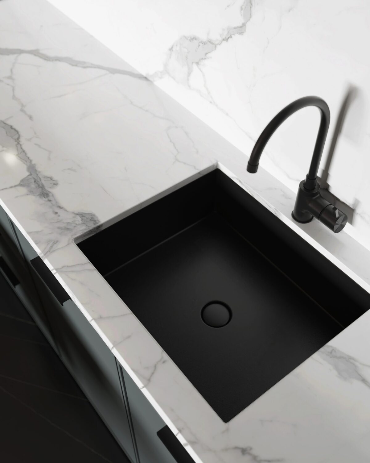 Modern kitchen with black sink and marble countertop.
