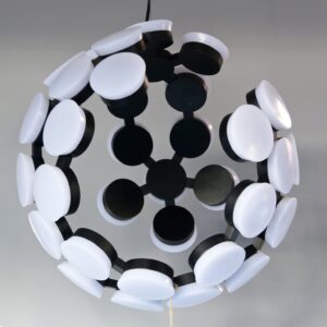 Modern spherical chandelier with black and white circular elements.