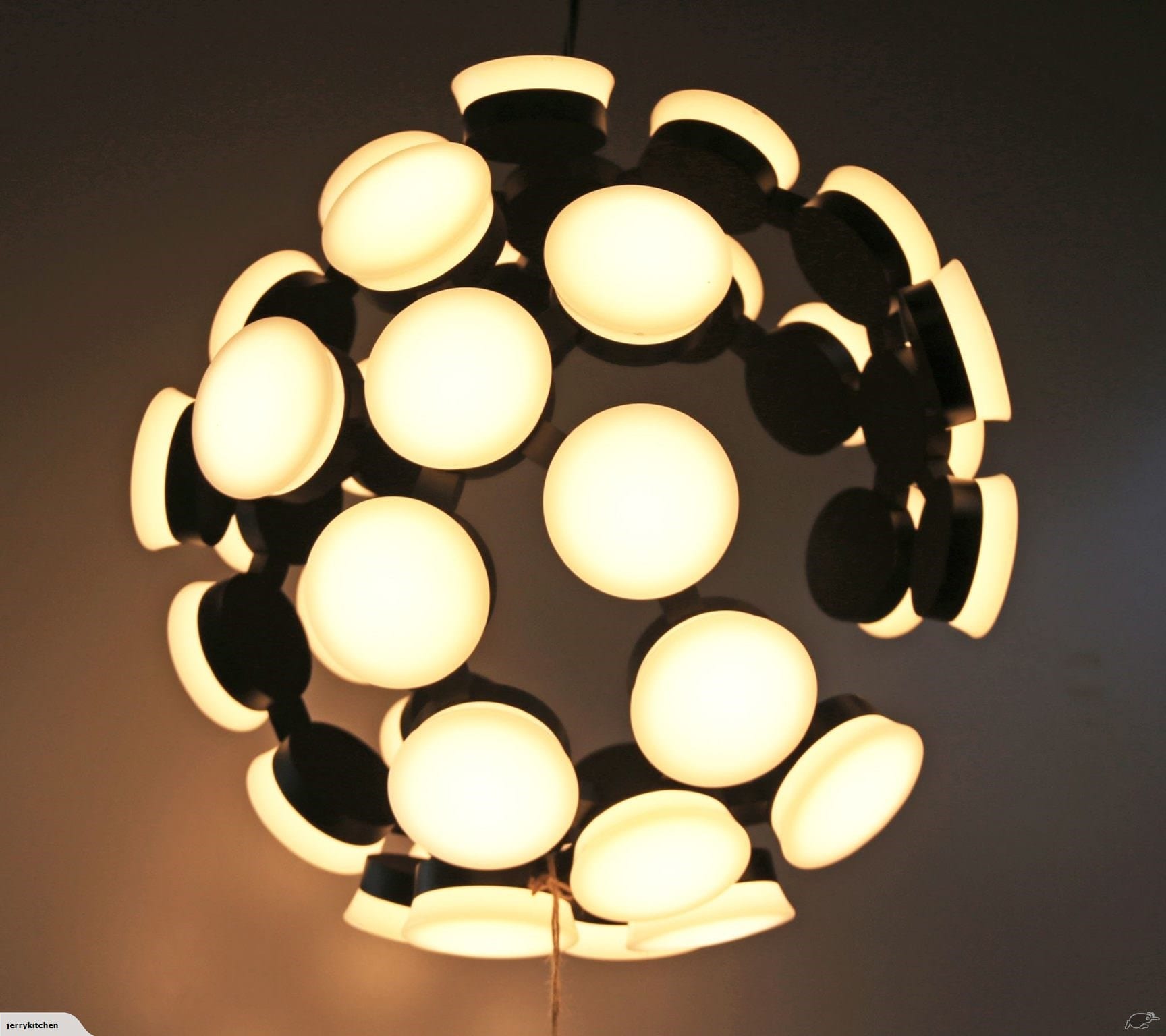 Modern spherical ceiling light with glowing circular bulbs.