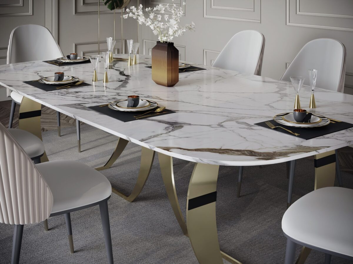 Elegant dining table with marble top and gold legs, set for a meal.