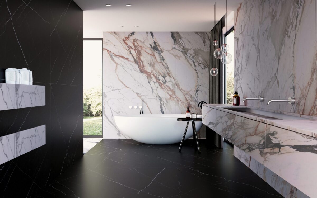 Modern bathroom with marble walls and freestanding bathtub.