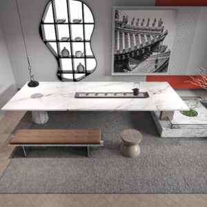 Modern kitchen with white marble island and decorative wall art.