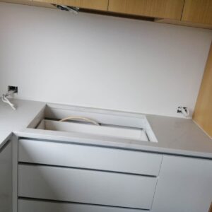 Modern kitchen with Calacatta Belleza countertops and wooden cabinets.