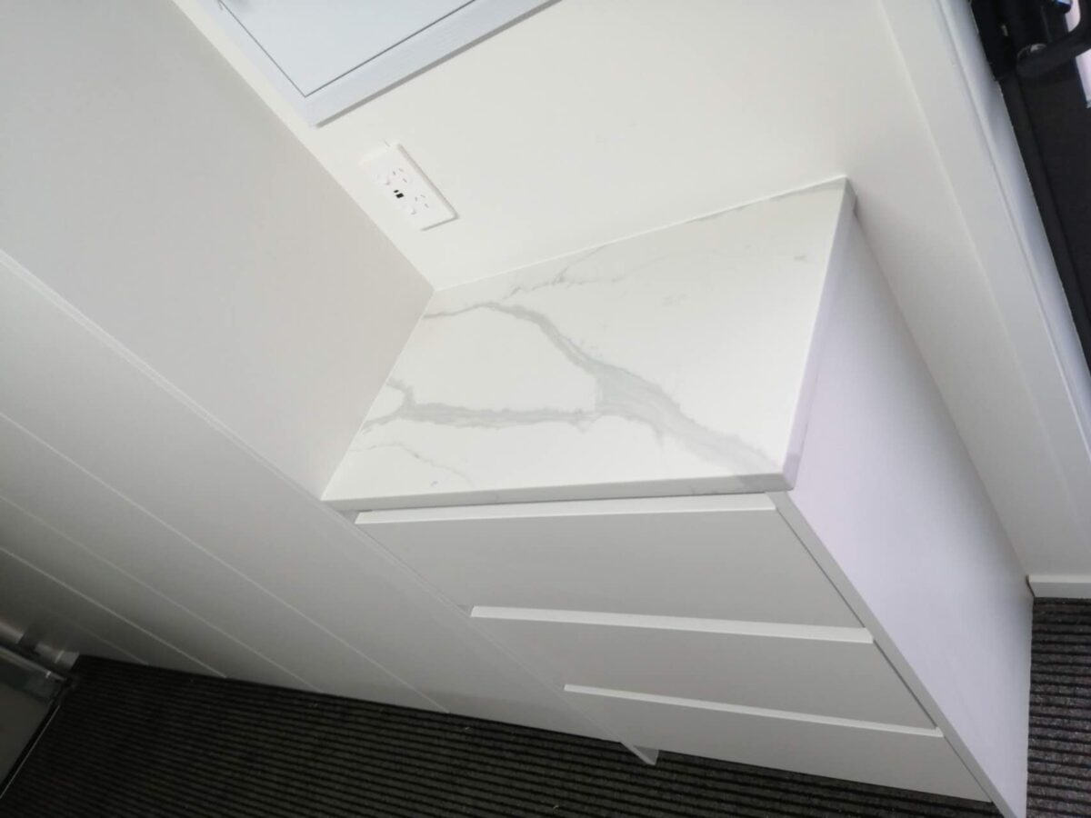 Calacatta Sky Quartz countertop on white cabinet in modern kitchen.