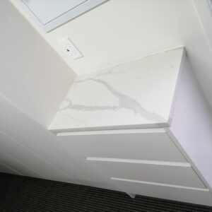 Calacatta Sky Quartz countertop on white cabinet in modern kitchen.