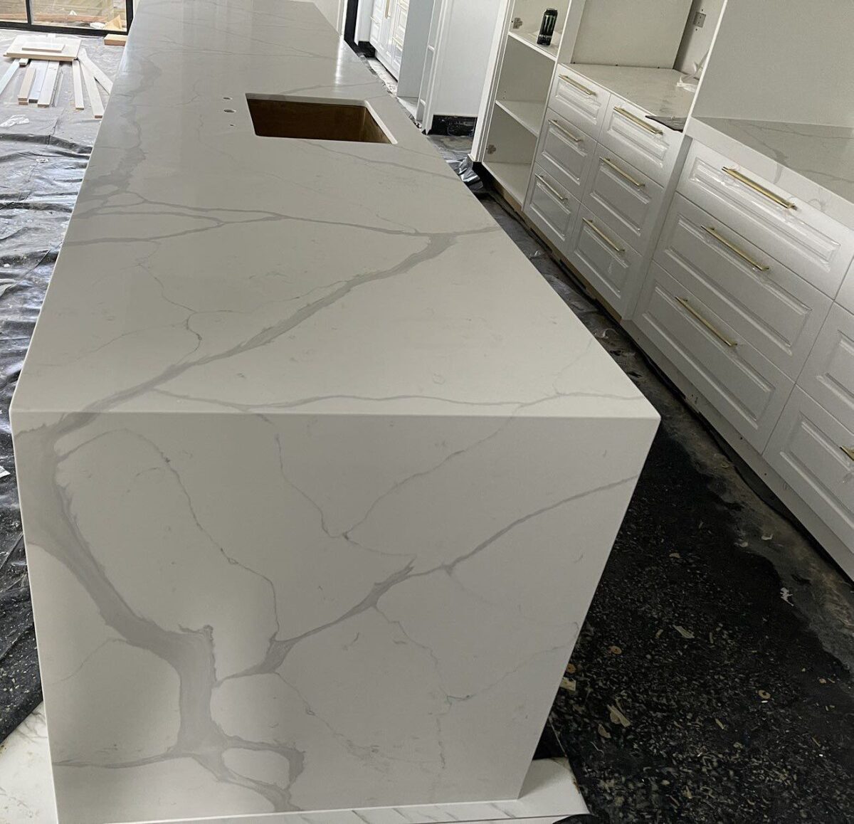 Calacatta Sky Quartz countertop in modern kitchen setting.