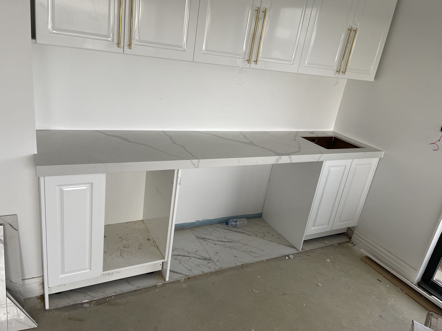 White kitchen cabinets with Calacatta Sky Quartz countertop.