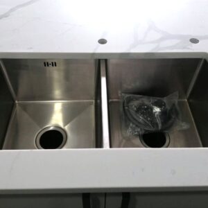 Double stainless steel sink on Calacatta Sky Quartz countertop.