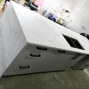 Calacatta Sky Quartz kitchen island with sink and drawers.