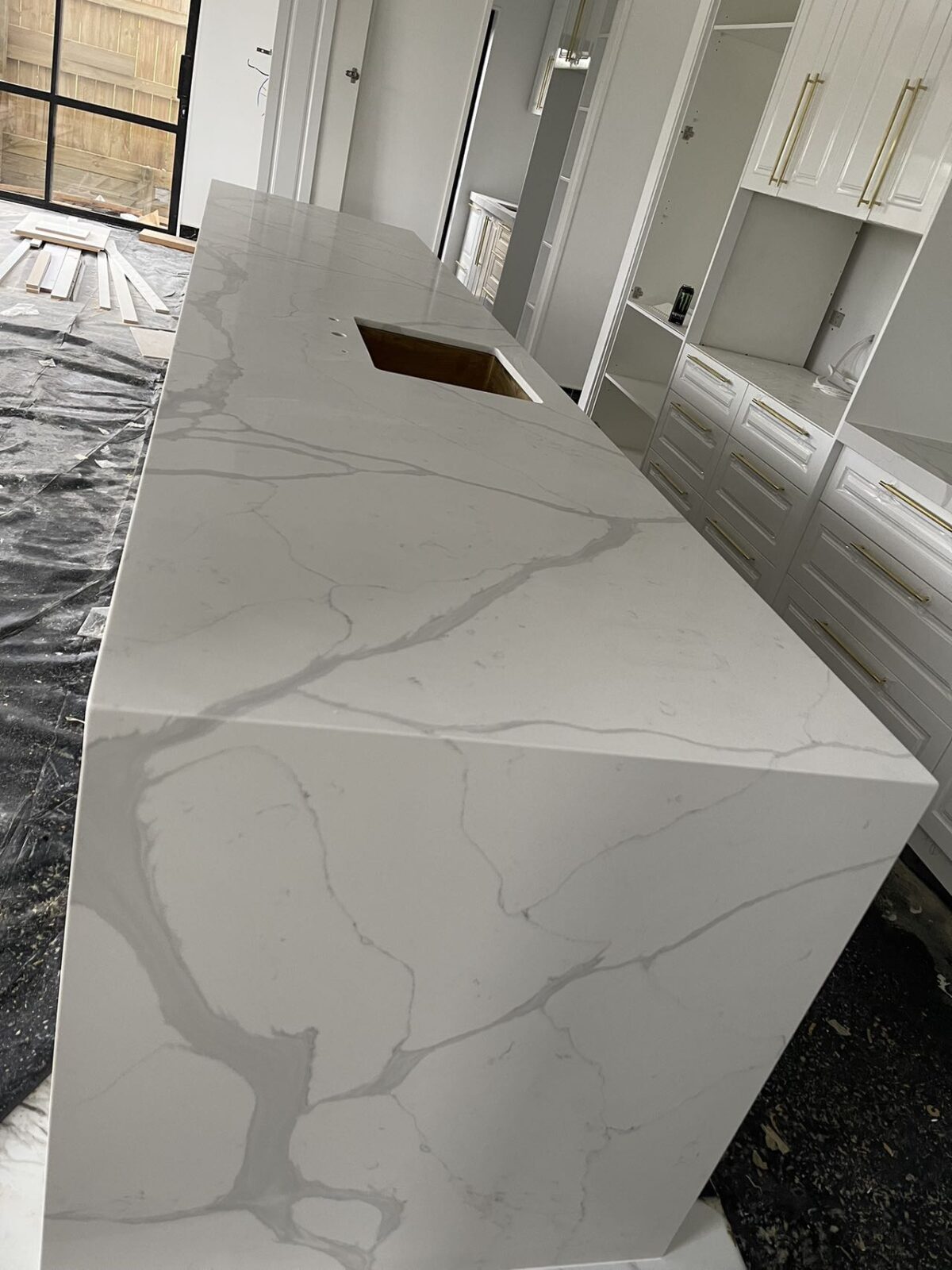 Calacatta Sky Quartz kitchen countertop installation in progress.