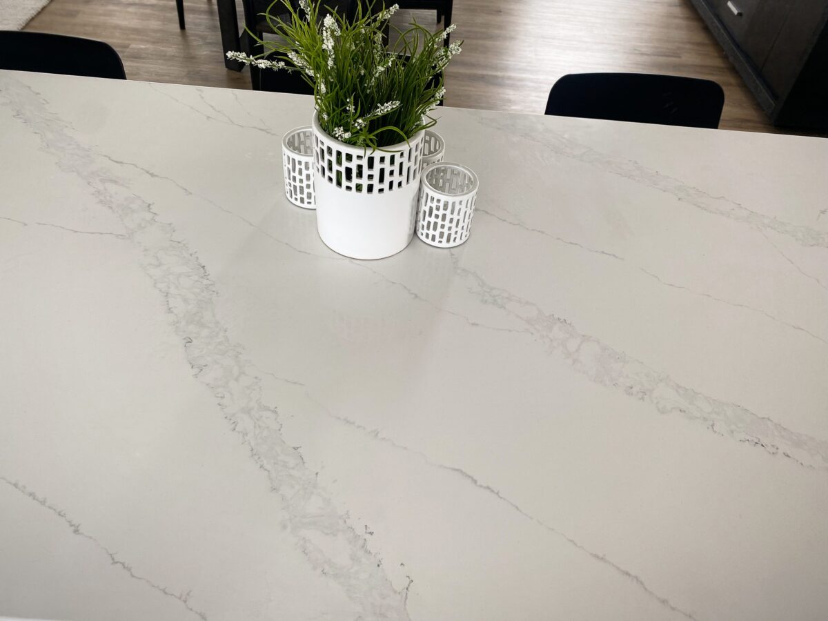 Marble countertop with plant and candle holders.