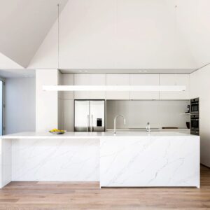 Modern kitchen with white marble island and minimalist design.
