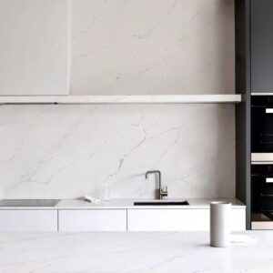 Modern kitchen with marble countertops and minimalist design.