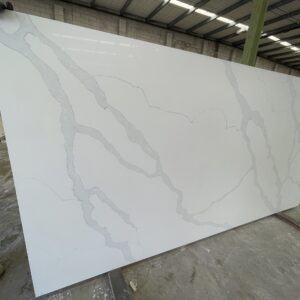 White marble slab with gray veining in a warehouse.