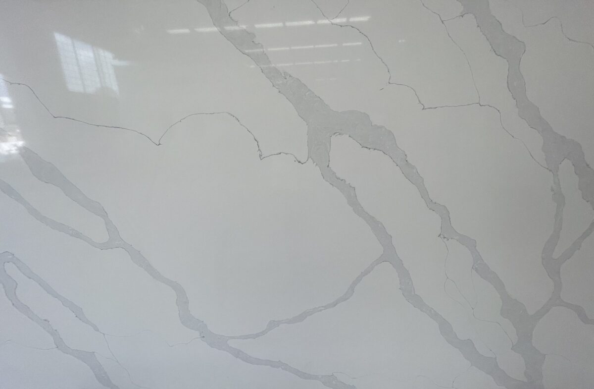 White marble countertop with gray veining pattern.