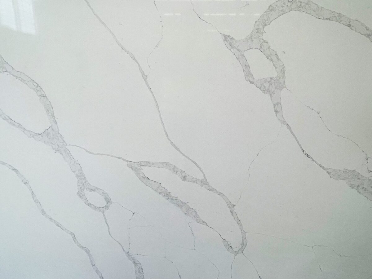 White marble countertop with subtle gray veining pattern.