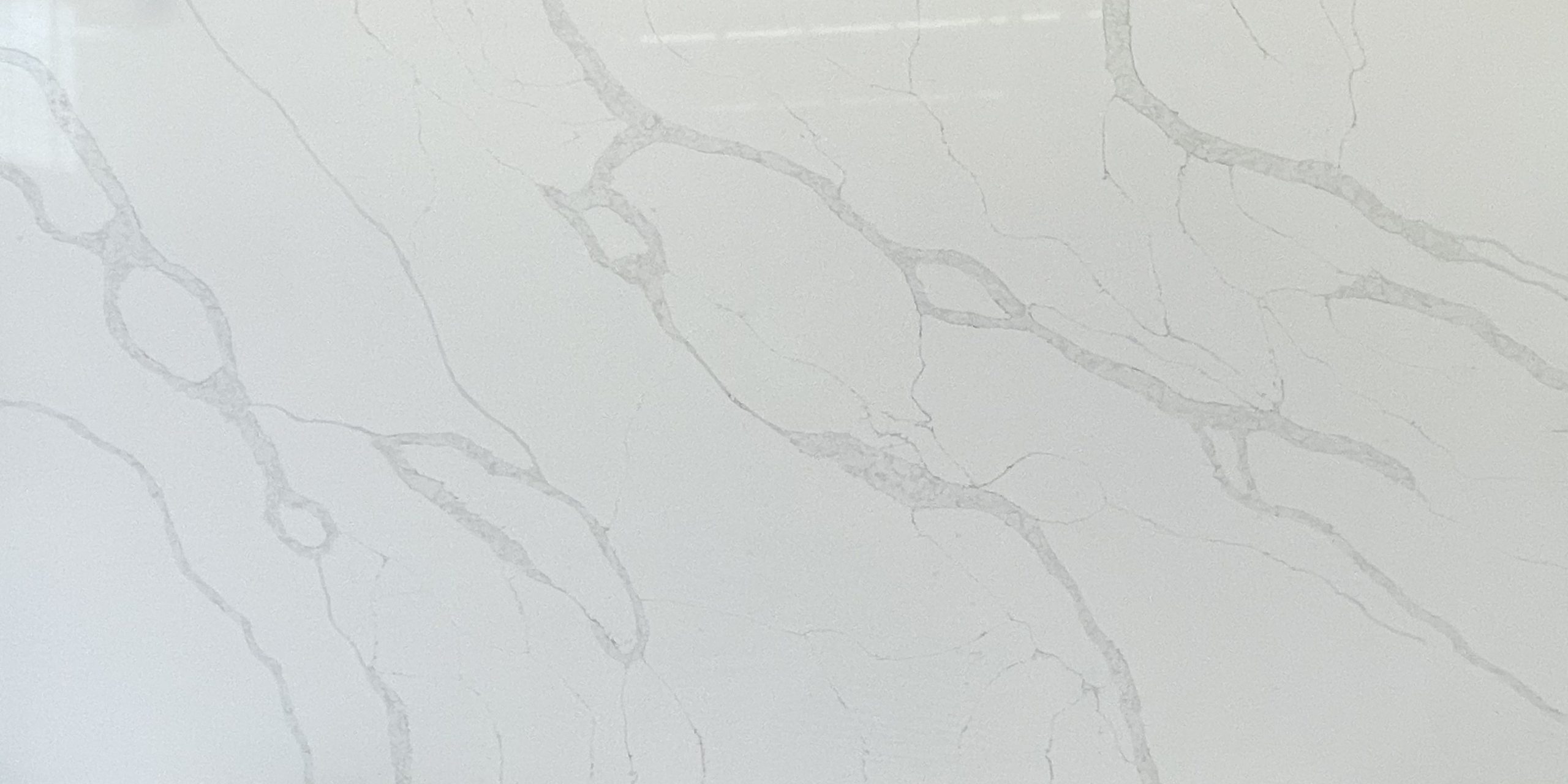 White marble countertop with subtle gray veining.