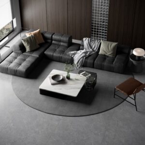 Modern living room with dark sectional sofa and marble coffee table.