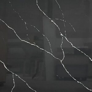 Dark marble countertop with white veining pattern.