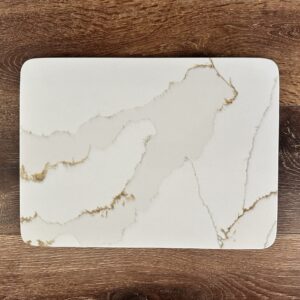 Marble-patterned rectangular cutting board on wooden surface.