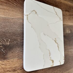 Marble cutting board on wooden kitchen counter.