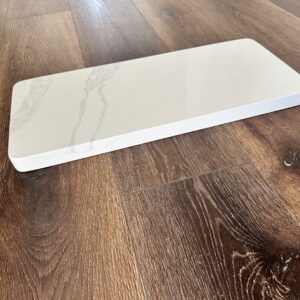 Marble countertop sample on wooden floor.