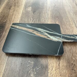 Marble cheese board on wooden floor.