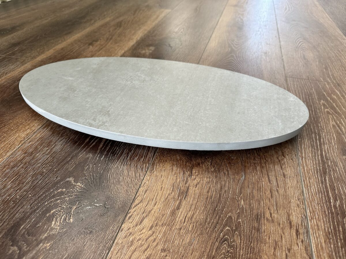 Round stone plate on wooden floor.
