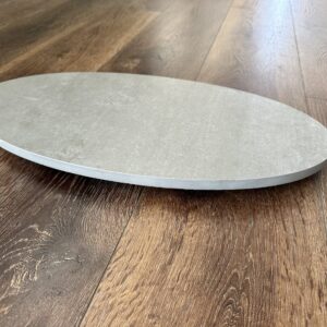 Round stone plate on wooden floor.